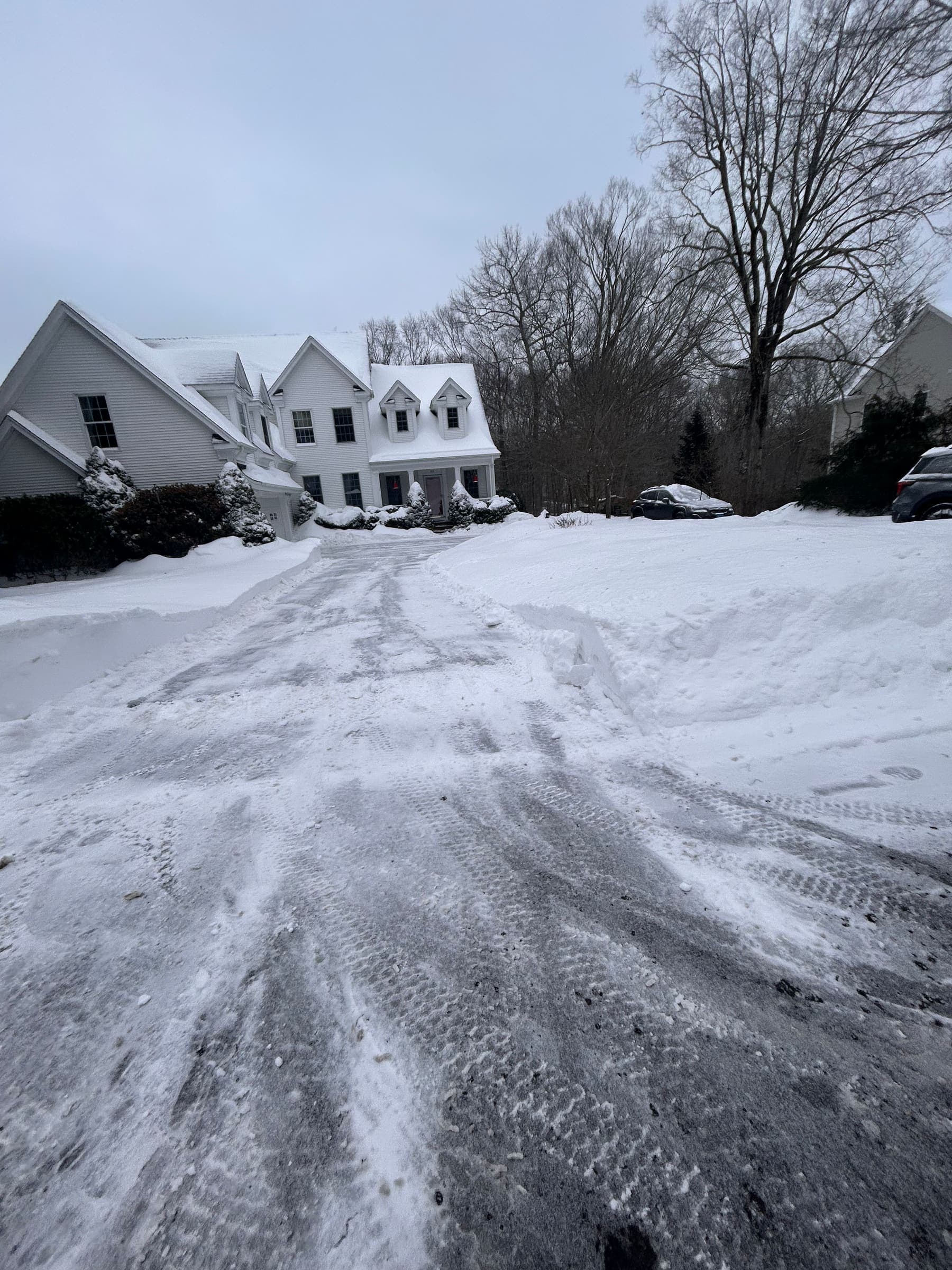 Driveway plowed clear to the pavement up to the garage at a Madison, CT home after a snowstorm